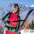 Attractive woman removing Hagan hybrid climbing skins from backcountry skis.