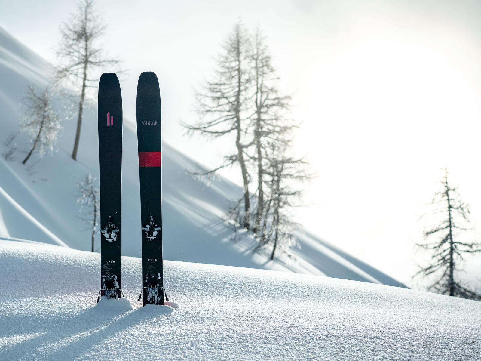 A Boost 105 stands straight up out of an untracked snowy hillside.