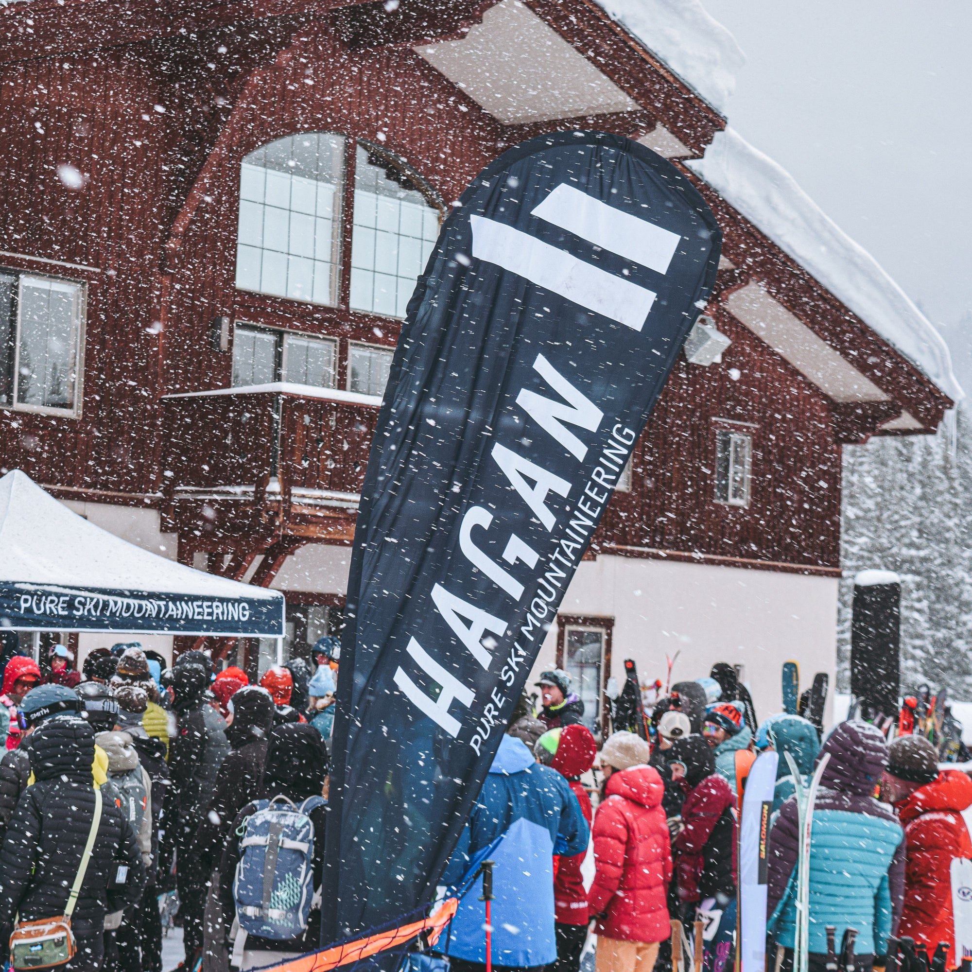 Hagan tent at a snowy event with people and tents in the background