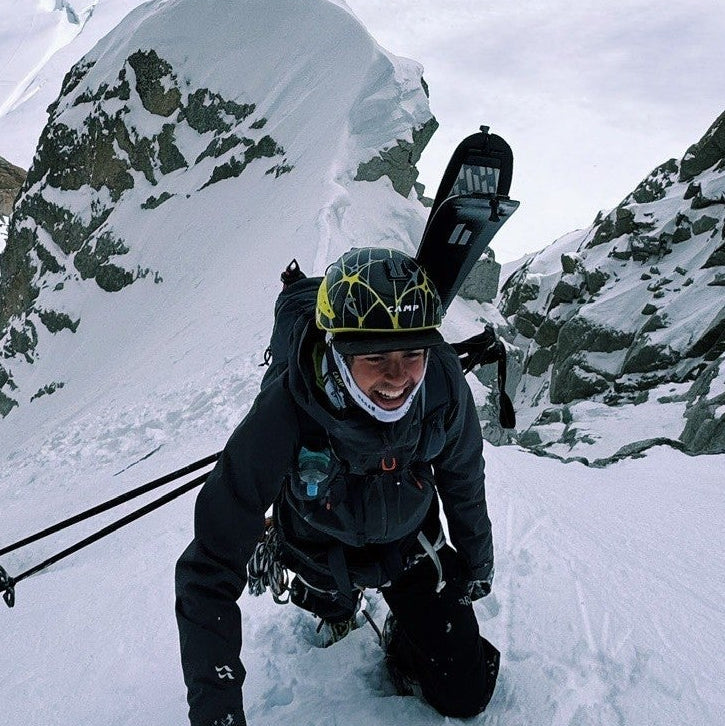 Person with skiing equipment on a snowy mountain
