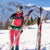 Attractive woman removing Hagan hybrid glue climbing skins from Hagan Ultra 82 backcountry touring skis